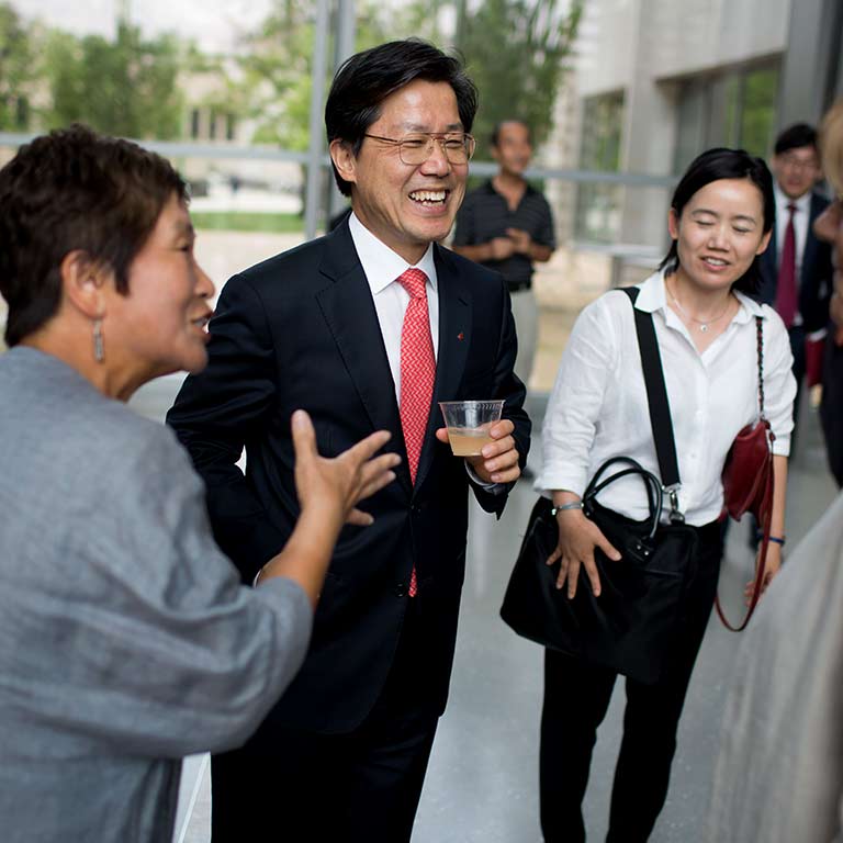 Three people talk and laugh.