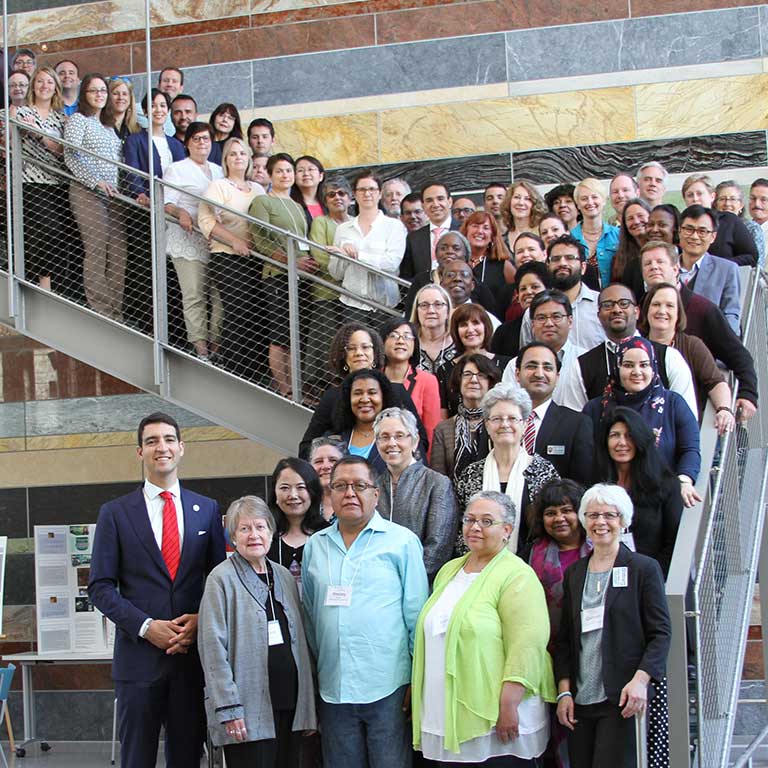 A large group poses on a staircase.
