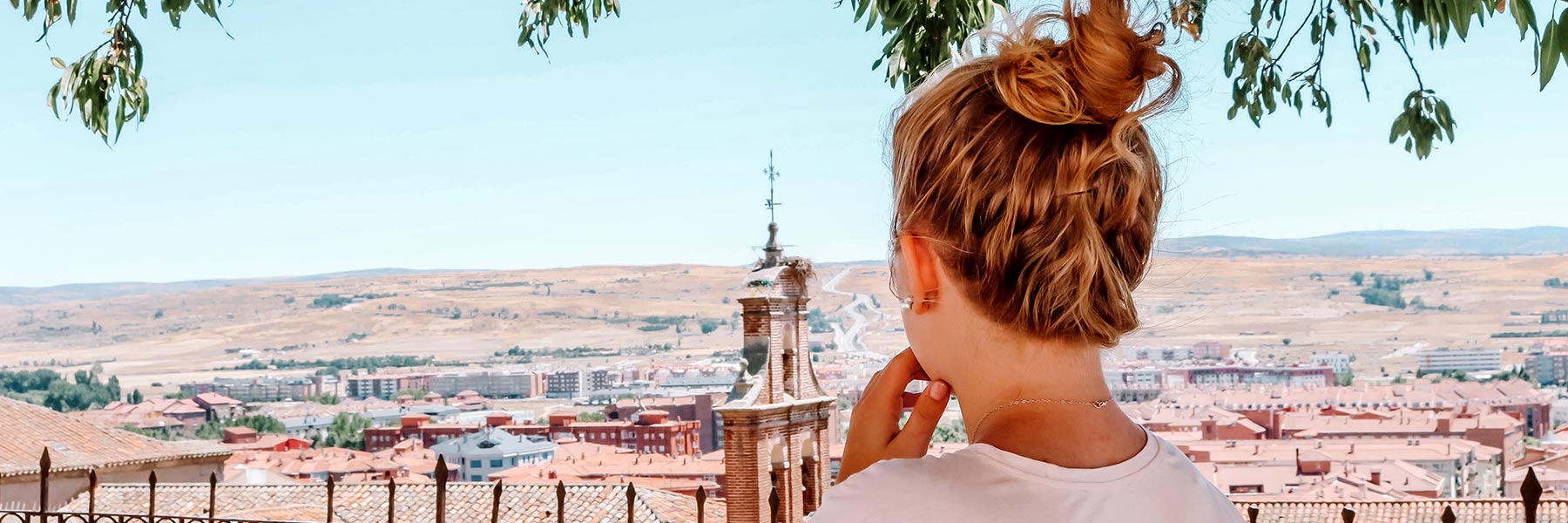 A student looks out over a foreign cityscape.
