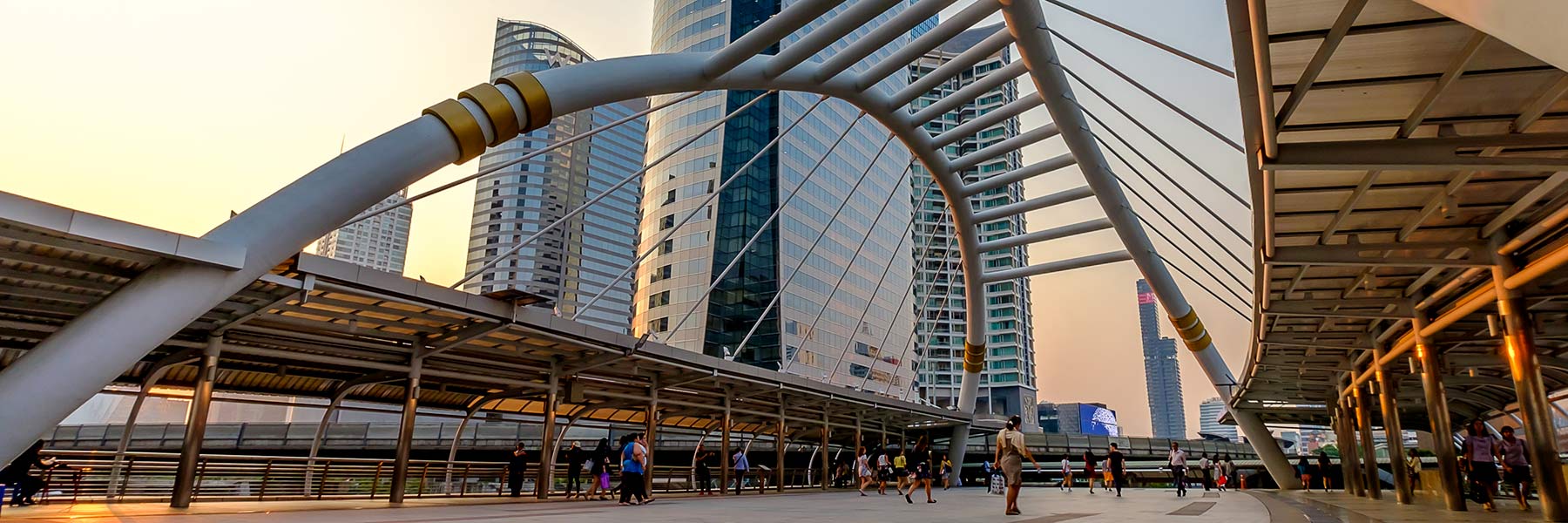Pedestrians stroll during early evening in Bangkok.
