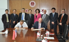 Indiana University President Michael A. McRobbie, seated at right, and Zhang Baosheng, vice president of China University of Political Science and Law, sign an agreement creating a new partnership academy.