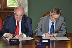 McRobbie signing an agreement.