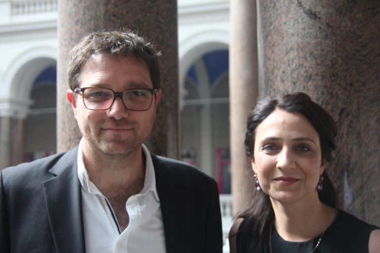 Man and woman posing in an atrium.