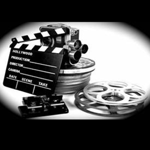 Black and white photo of film canisters and movie camera.