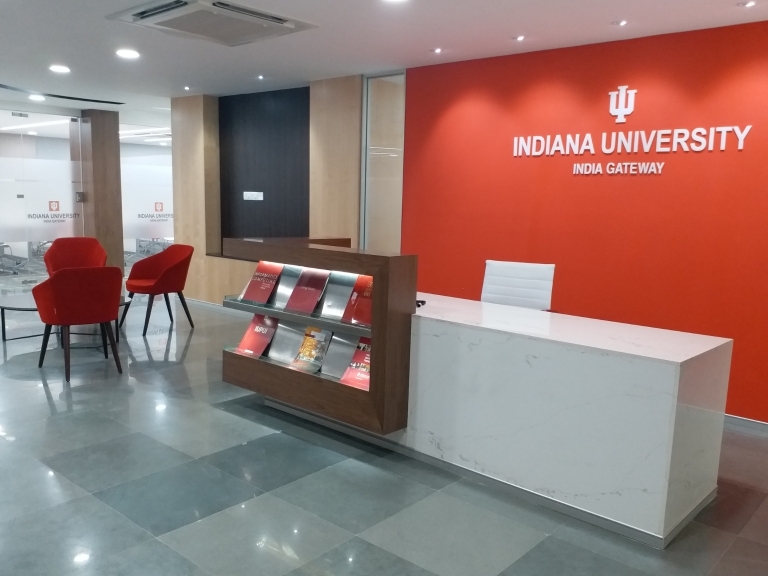 India gateway lobby with front desk and chairs.